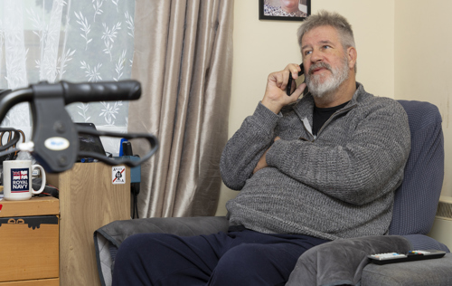 Elderly man on the phone, in his chair