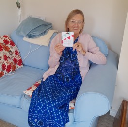 A photo of the survey prize winner Dawn holding a gift card.