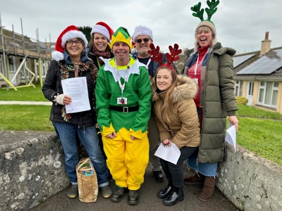 photo of Cornwall Housing staff wearing festive clothing to go carol singing to residents