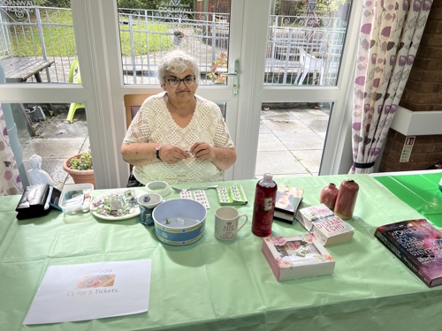 resident sat at table raising funds at coffee morning