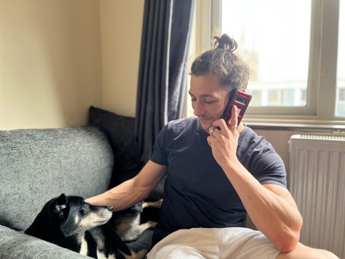 Man on the phone with dog