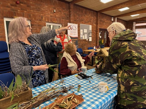 A photo of residents making bug houses for the new garden