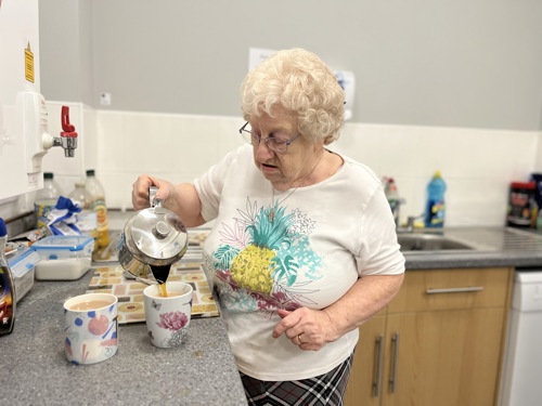 Elderly lady making a cup of tea