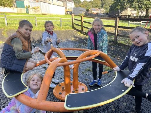 children painting play equipment as part of Gunnislake Action Day
