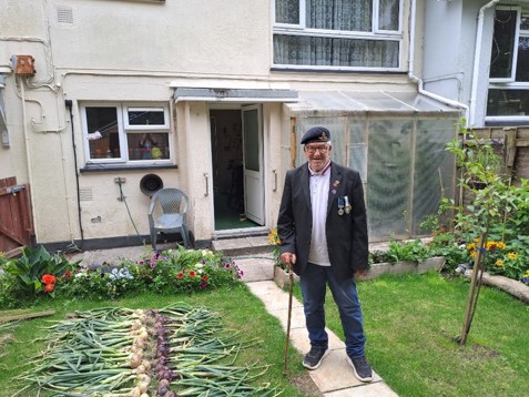 Derek with all the onions he’s grown - laid out for his neighbours