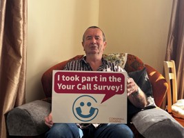your call survey winner sat with winning sign