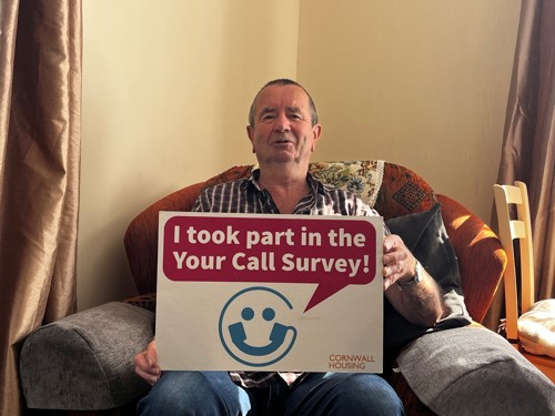 Man holding winning your call survey sign