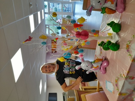 Scheme Management Officer at Albion Court posing by Easter decorations