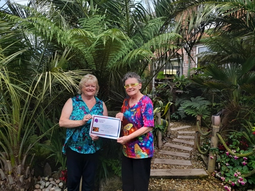 Bridget presenting Angie with her certificate.