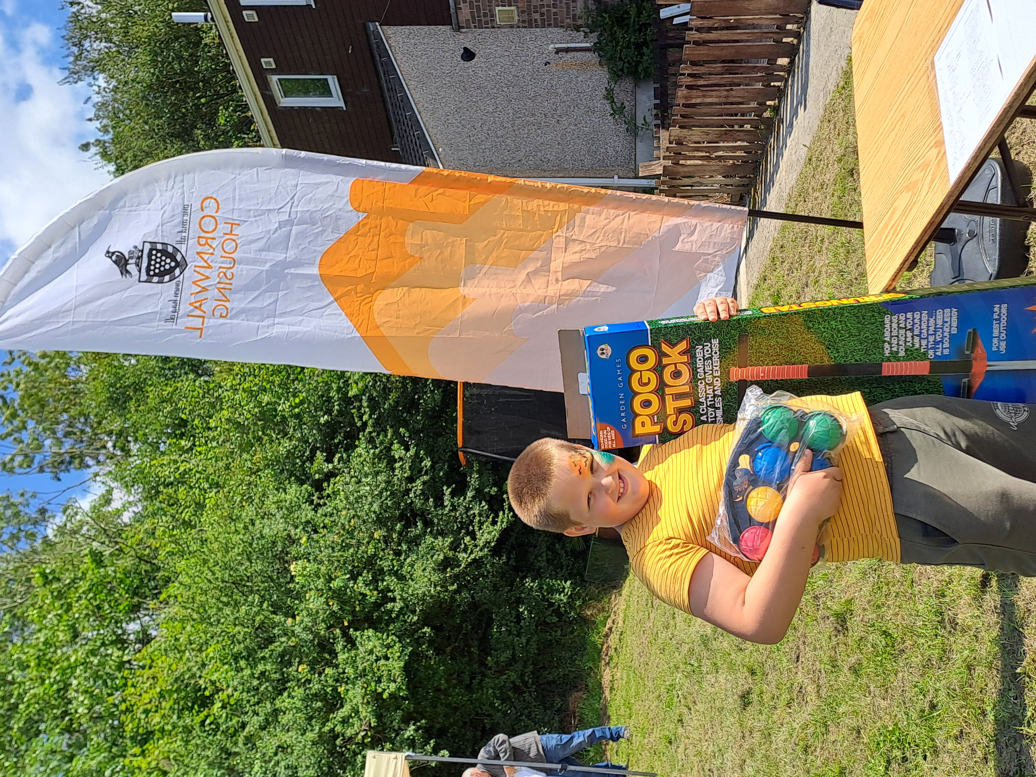picture shows a boy with his prizes at a community fun day at Kinsman Estate Bodmin
