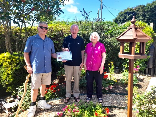 Chair of the Tenants’ Forum, John, presenting Teresa and Shaun with their certificate.