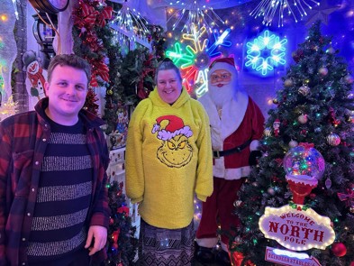 A photo of Mum and son surrounded by their Christmas decorations