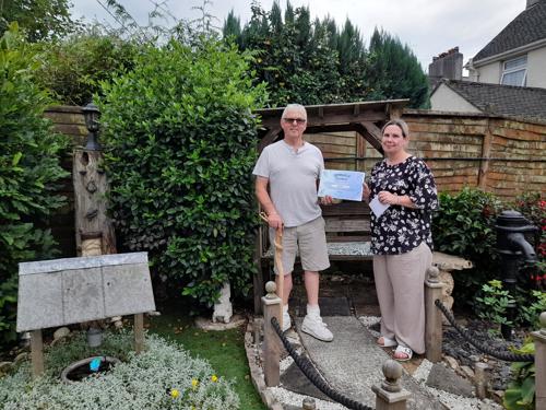 Chair of Tenant forum John presenting Natalie with 2nd prize certificate